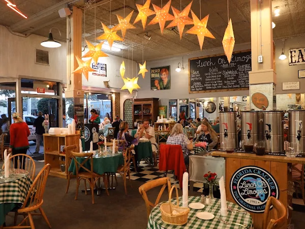 Diners at Florida Cracker Kitchen restaurant, star lanterns overhead, green checkered tablecloths